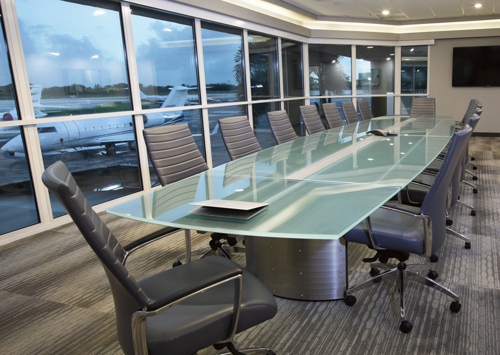 A Stoneline Designs custom conference table from the Crescent Collection. This 20' table with boat shaped frosted glass makes a statement in a conference room.