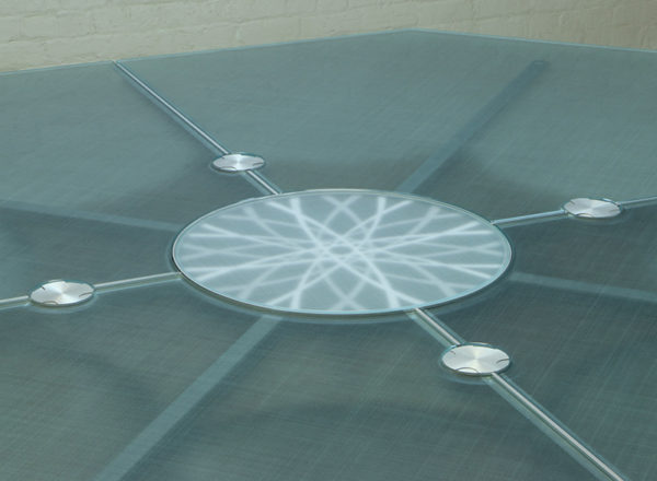 A round Conference Table with a center logo under back lit Glass.
