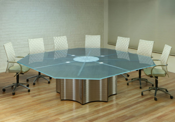 An Octagon shape Conference Table from our Crescent line with a Glass top and Stainless Steel base.