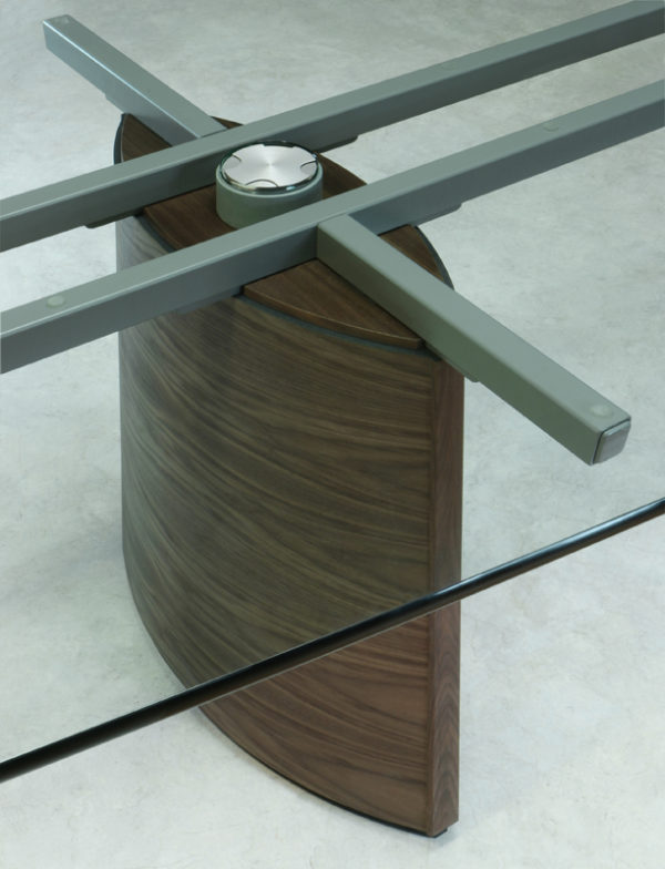 Custom conference tables with Clear glass that expose the all walnut pedestal with integrated wiring.