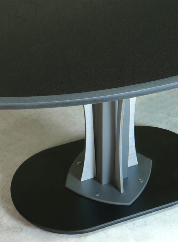 Tangent table with an Oval Shaped Black Granite top
