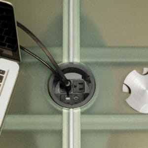 wiring-grommet A Stoneline Designs wiring grommet provides conference table power.