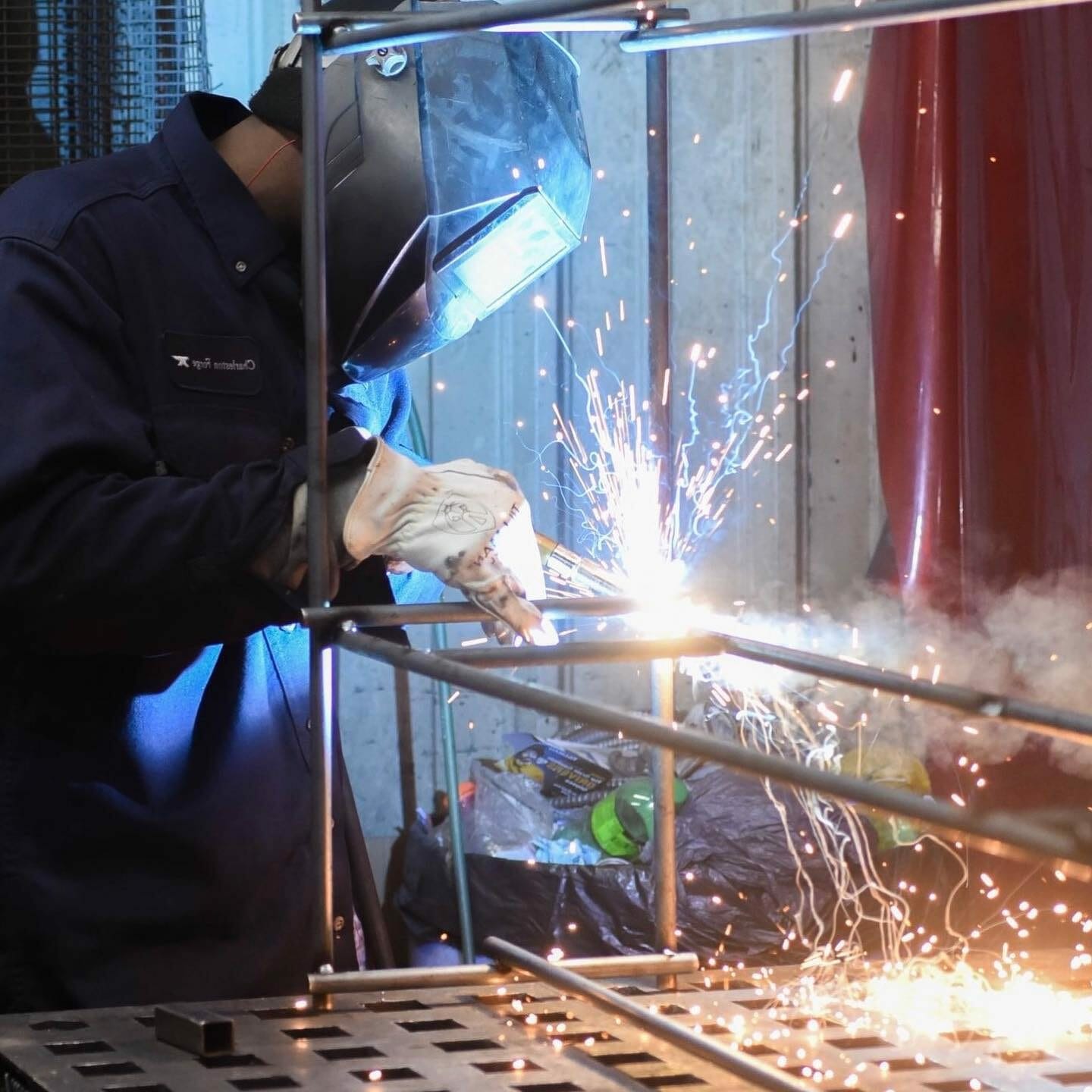Sparks fly as a Stoneline Designs welder puts the finishing touches on a piece of custom executive office furniture.
